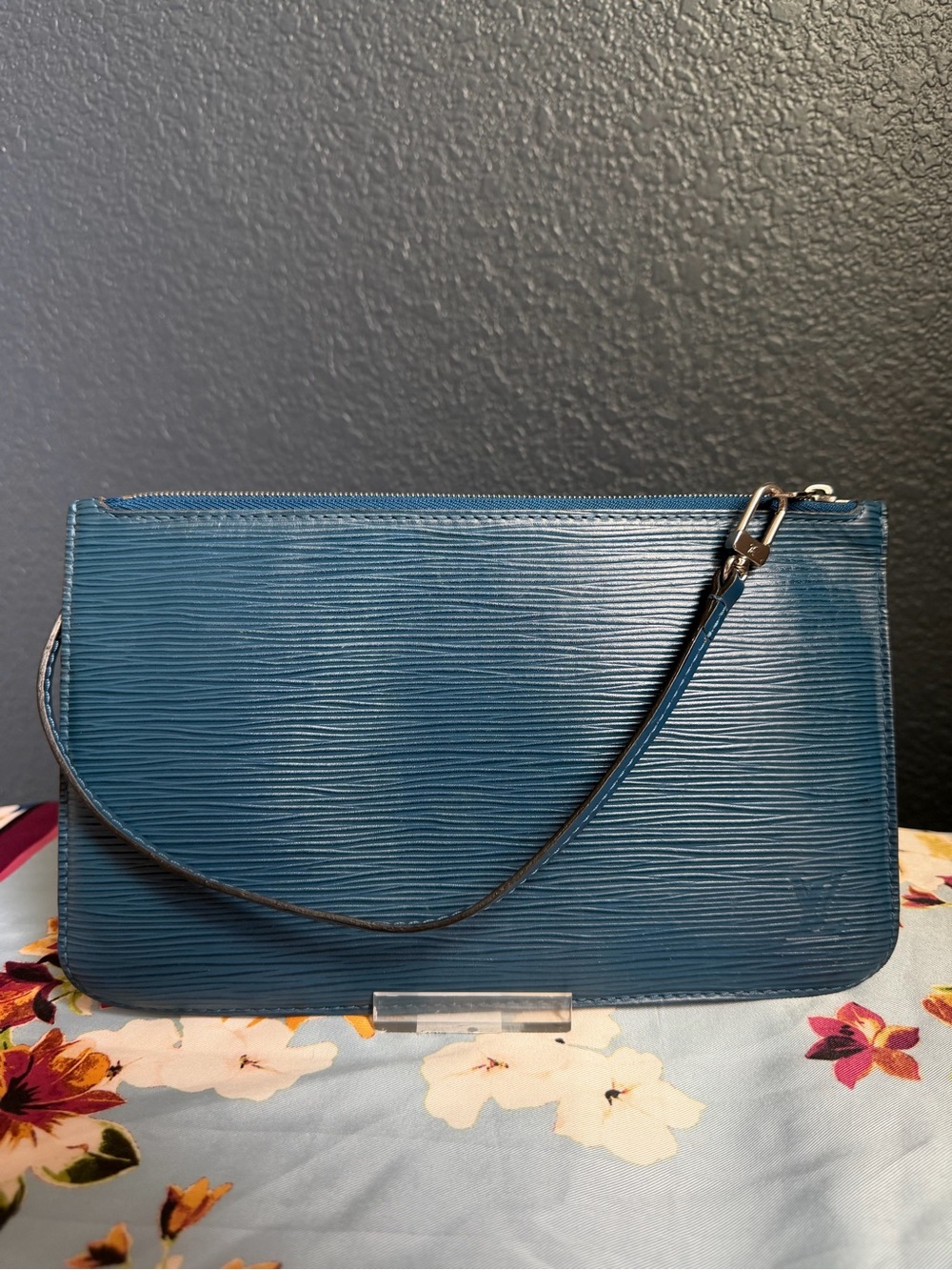 The Louis Vuitton Epi Leather Teal Neverfull Pochette Wristlet